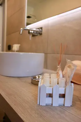 a bathroom counter with a sink and a bunch of dishes at Residenza a San Pietro in Rome