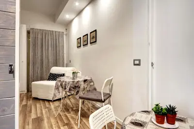 a living room with a table and a chair at Pianeta Roma 62 in Rome