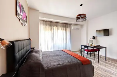 a bedroom with a bed and a table and a desk at Pianeta Roma 62 in Rome