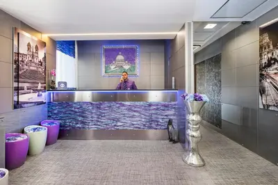 a man standing behind a counter in an aquarium in a bathroom at Hotel Relais Dei Papi in Rome