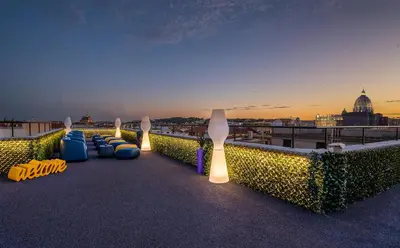 a group of chairs sitting on the roof of a building at Hotel Relais Dei Papi in Rome
