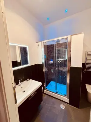 a bathroom with a shower and a toilet and a sink at Chroma Italy - Chroma Tessera in Rome