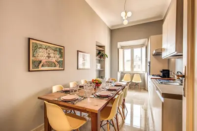 a dining room with a long table and chairs at The Great Retrò in Rome