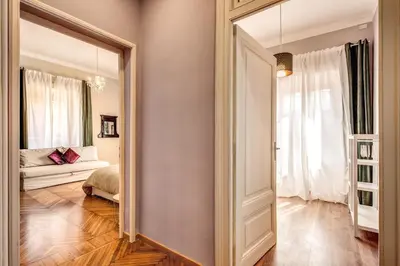 a bedroom with a mirror and a bed in a room at The Great Retrò in Rome