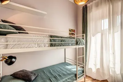 a room with bunk beds with a window at The Great Retrò in Rome