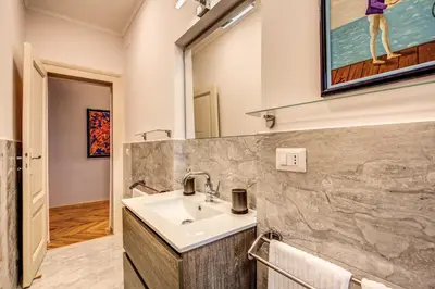 a bathroom with a sink and a mirror at The Great Retrò in Rome