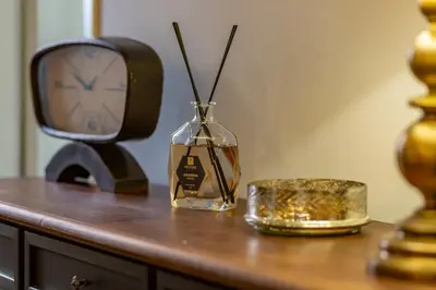 a clock and a glass vase on a table at Palazzo storico Dormo da Lisa - Colosseo in Rome