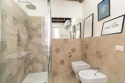 a bathroom with a shower and a toilet and a sink at Palazzo storico Dormo da Lisa - Colosseo in Rome
