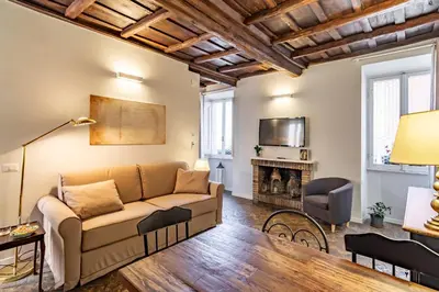 a living room with a couch and a fireplace at Palazzo storico Dormo da Lisa - Colosseo in Rome