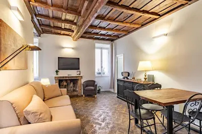 a living room with a couch and a table at Palazzo storico Dormo da Lisa - Colosseo in Rome