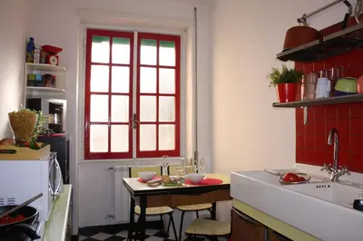 a kitchen with a sink and a red window at Arches B&B in Rome