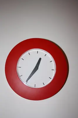 a clock on a wall with a red frame at Arches B&B in Rome