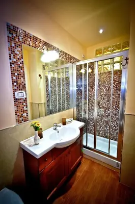 a bathroom with a sink and a shower at Relais Cavour in Rome
