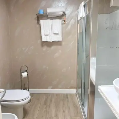 a bathroom with a shower and a toilet and a sink at Relais Villa Coppedè in Rome