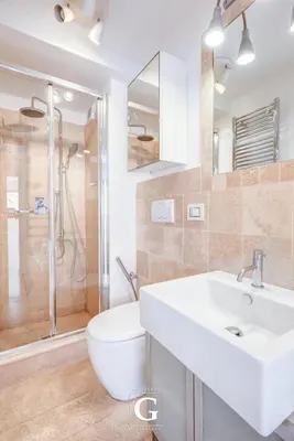 a bathroom with a white sink and a shower at Residenza Gonfalone in Rome