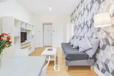 a living room with a couch and a tv at Residenza Gonfalone in Rome