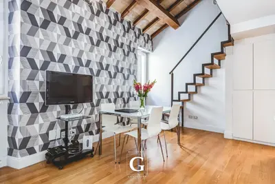 a dining room with a table and a tv at Residenza Gonfalone in Rome