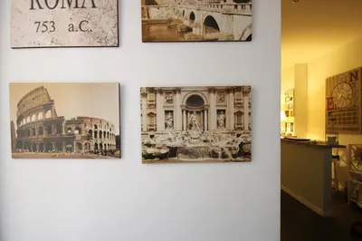 a group of pictures hanging on a wall at Le Cupole in Rome