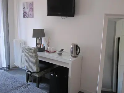 a desk in a bedroom with a bed and a lamp at Le Cupole in Rome