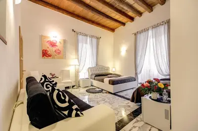 a living room with a couch and a chair at Il Fascino Di Roma in Rome