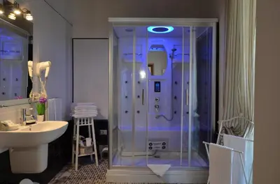 a bathroom with a glass shower and a sink at Il Fascino Di Roma in Rome
