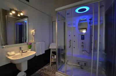 a bathroom with a glass shower and a sink at Il Fascino Di Roma in Rome