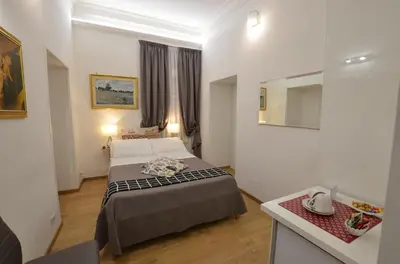a hotel room with a bed and a mirror at Il Fascino Di Roma in Rome