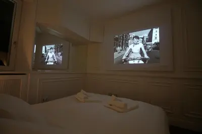 a bedroom with two televisions and a bed with two towels at Charm & Design in Gourmet District in Rome