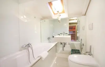 a bathroom with a tub and a sink and a toilet at Charm & Design in Gourmet District in Rome