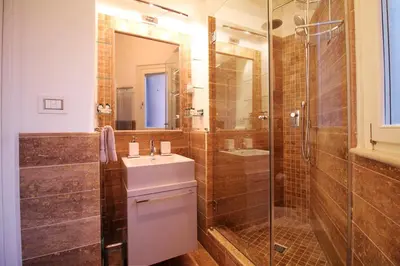 a bathroom with a sink and a shower at Charm & Design in Gourmet District in Rome