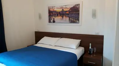 a bedroom with a blue bed and a painting on the wall at Roma My Home B&B in Rome