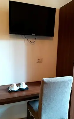 a desk with a chair and a television on a wall at Roma My Home B&B in Rome