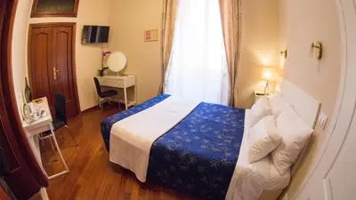 a hotel room with a bed and a window at Hotel Martino Ai Monti in Rome