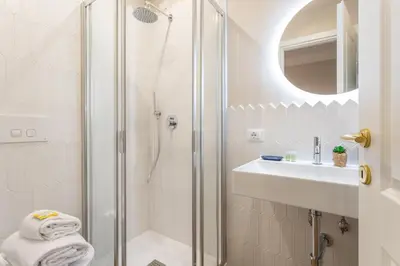 a bathroom with a shower and a sink at Rome Central Inn in Rome