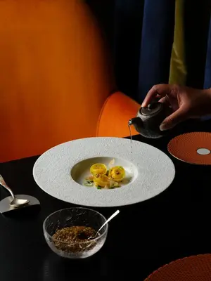 a plate with some food on top of a table at The Pantheon Iconic Rome Hotel, Autograph Collection in Rome
