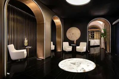 a lobby with a waiting room with white chairs and a table at The Pantheon Iconic Rome Hotel, Autograph Collection in Rome