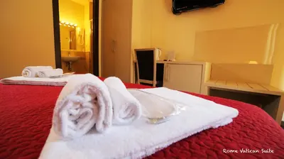 a hotel room with towels on a bed at Rome Vatican Suite in Rome
