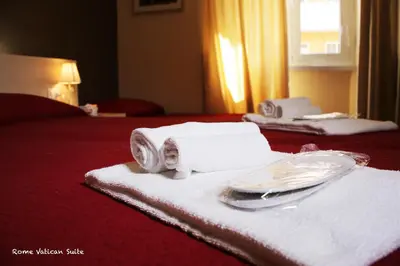 a hotel room with towels and a plate and napkin at Rome Vatican Suite in Rome