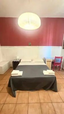 a bedroom with a large bed in a room at Meltin' Rome Guest House in Rome