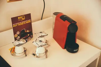 a table with a book and a hair dryer and a tie at Lighthouse Suites Trastevere in Rome