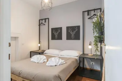two beds in a small room with two tables at CS Campo de'Fiori - Navona Amazing Terrace Apartment in Rome