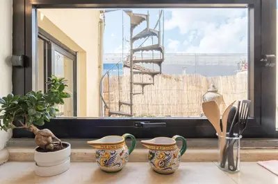 a window with three vases sitting on a window sill at CS Campo de'Fiori - Navona Amazing Terrace Apartment in Rome