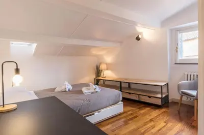 a small bedroom with a bed and a desk at CS Campo de'Fiori - Navona Amazing Terrace Apartment in Rome