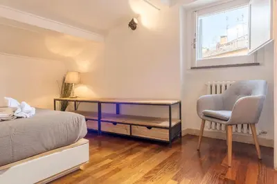 a bedroom with a bed and a desk and a chair at CS Campo de'Fiori - Navona Amazing Terrace Apartment in Rome
