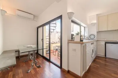 a kitchen with a glass table and a table at CS Campo de'Fiori - Navona Amazing Terrace Apartment in Rome