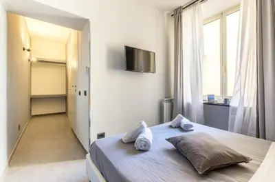 a bedroom with a bed with two pillows on it at Merulana 139 Suites in Rome