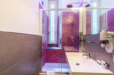 a bathroom with a sink and a shower at Merulana 139 Suites in Rome