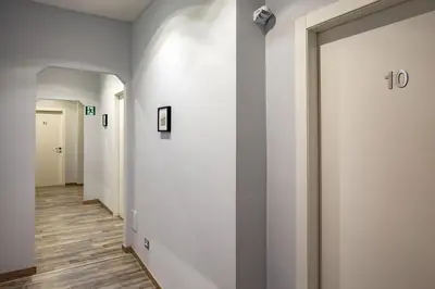 a hallway with white walls and wooden floors at Prima Guest House Collection in Rome