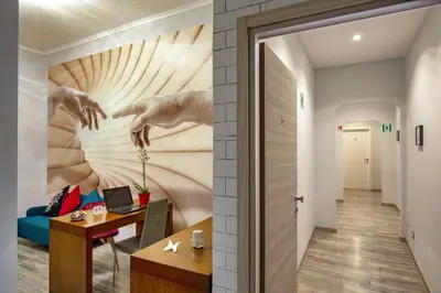 a hallway with a wall with a painting on it at Prima Guest House Collection in Rome