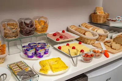 a buffet filled with different types of food on a counter at Prima Guest House Collection in Rome